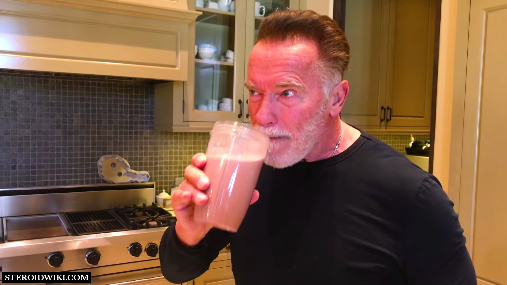 Arnold sipping protein shake